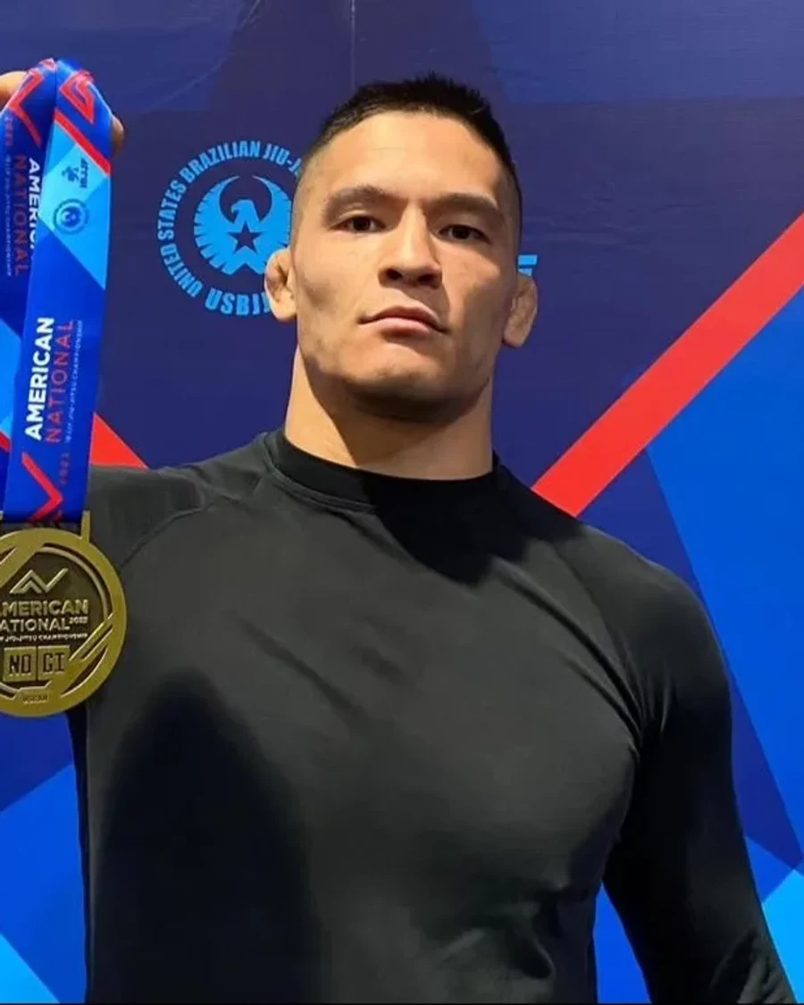 Max Li holding an IBJJF American National gold medal